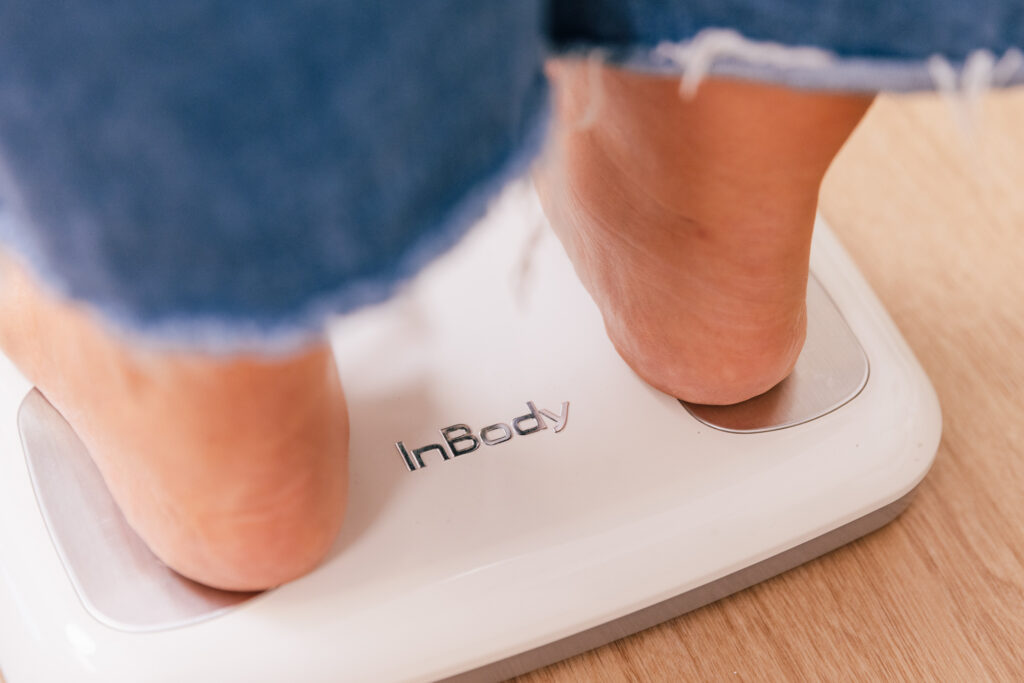 A patient at The Pip RX uses the InBody scale, which helps to fully scan and analyze their weight and the weight they have lost. Body composition measurements are an important part of our weight loss program near Lenexa.