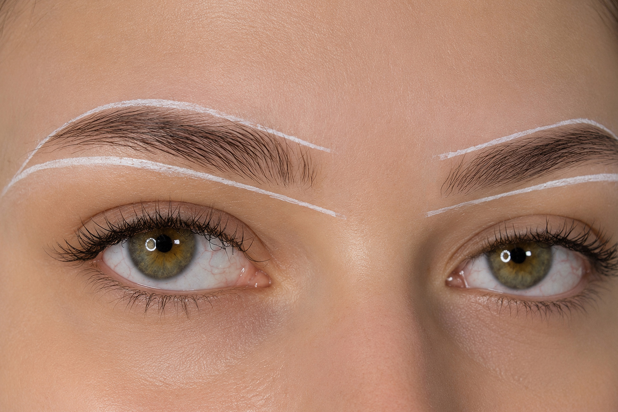 Esthetician performing a professional brow wax to shape and define a client's natural eyebrows at The Pip Rx in Overland Park.